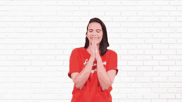a woman wearing a red shirt with the word gratidao on the bottom