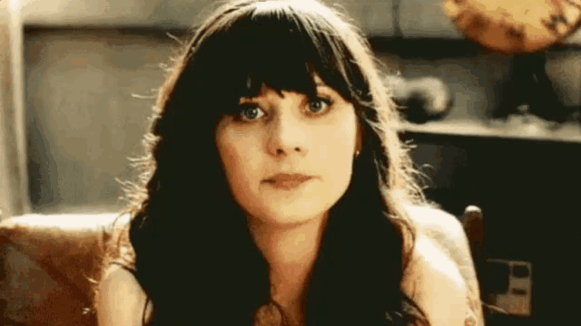 a close up of a woman 's face with a serious look on her face .