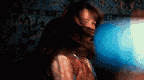 a blurry image of a woman 's face with a blue light behind her