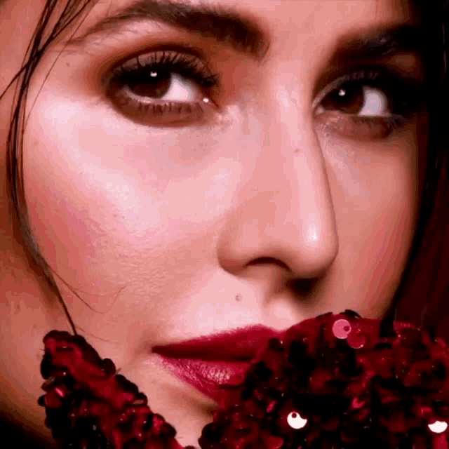 a close up of a woman 's face with red lips