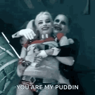harley quinn and the joker are hugging each other and the joker is saying `` you are my pudding '' .