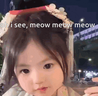 a little girl is wearing a headband with flowers on it and says oh i see meow meow meow