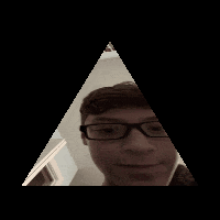 a man with glasses looks at himself in a mirror
