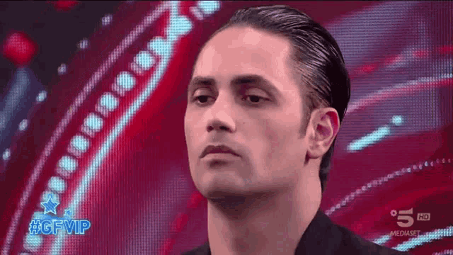 a man is standing in front of a screen that says gfvip