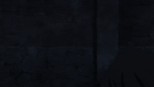 a man in a black jacket is holding his head in pain
