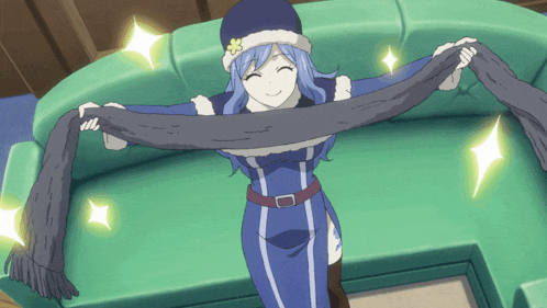 a girl in a blue dress is holding a scarf over her head