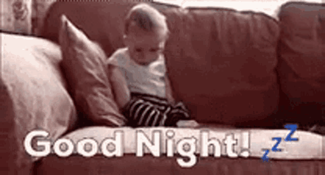 a baby is sitting on a couch with the words `` good night '' above him .