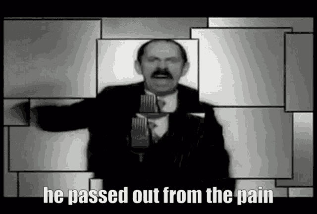 a man with a mustache is standing in front of a microphone with the words he passed out from the pain below him .
