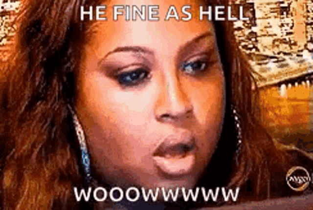 a woman is making a funny face with the words `` he fine as hell '' written on it .