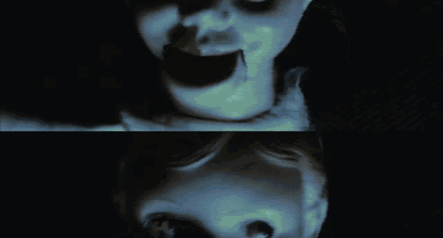 a close up of a creepy doll 's face with a black background