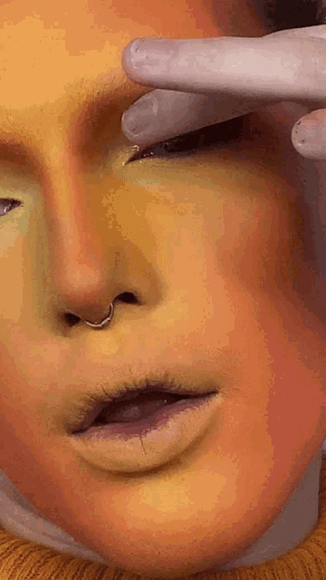 a close up of a person 's face with makeup on it