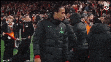 a soccer player wearing a jacket that says axa on it