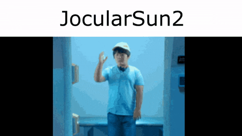a man in a blue shirt is standing in a doorway with jocularsun2 written on the bottom