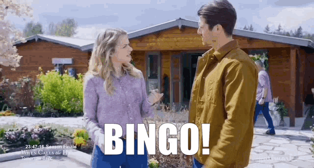 a man and a woman are standing in front of a house with the word bingo written on the screen