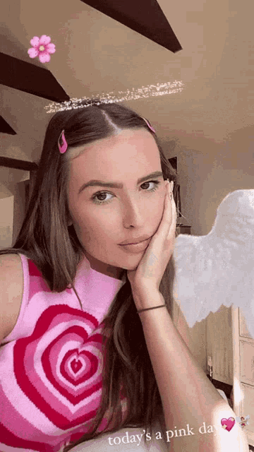 a woman wearing a pink top with a heart on it and the words today 's a pink day
