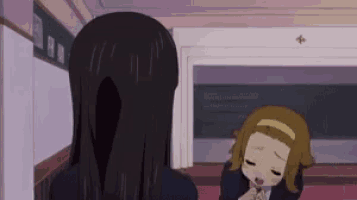 a couple of anime girls are standing next to each other in a room .