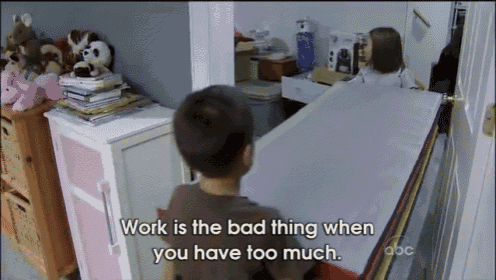 a boy sitting in a room with the words work is the bad thing when you have too much on the bottom