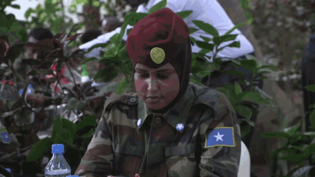 a woman in a military uniform with a blue star on her shoulder