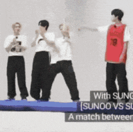 a group of people are standing on a blue mat with the words sunoo vs sg written on it