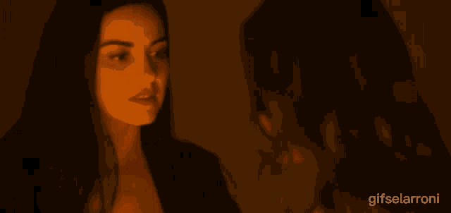 a woman touching another woman 's face with the words gifselarroni below