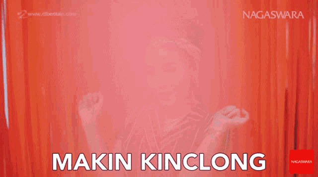 a woman is dancing in front of a red curtain with the words makin kinclong in white letters