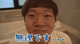 a man in a white shirt is smiling in front of chinese writing