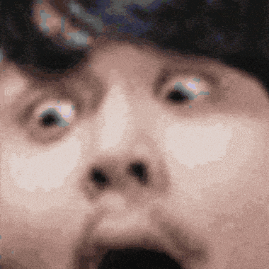 a close up of a person 's face with a surprised look on his face