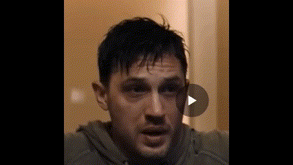 a close up of a man 's face with a play button behind him .