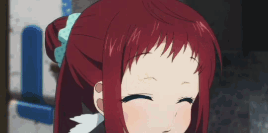 a close up of a girl with red hair making a face