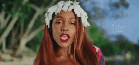 the woman is wearing a flower crown on her head .