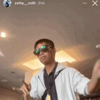 a man wearing sunglasses and a white shirt is standing in front of a ceiling ..