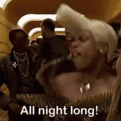 a man and a woman are standing next to each other and the woman is saying " all night long "