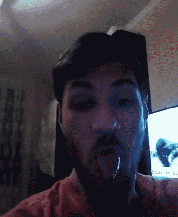a man with a beard sticking his tongue out