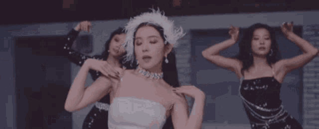 a group of women are standing in a circle dancing .