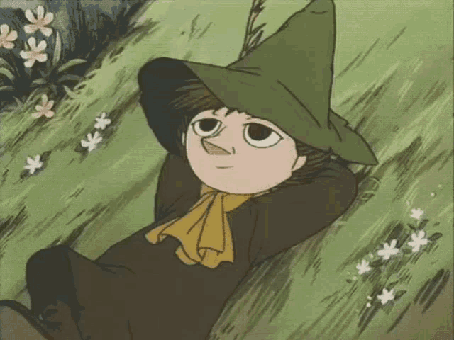 a cartoon character is laying in the grass with his hands behind his head and wearing a green hat .
