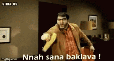 a man with a beard is holding a banana in his hand and says nnah sana baklava !
