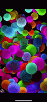 a bunch of colorful balloons are floating in the air on a black background
