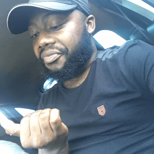 a man with a beard wearing a hat and a black shirt with a patch on it that says ' polo ' on it