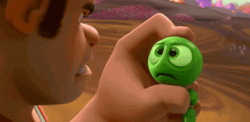 a cartoon character is holding a green worm and says no.