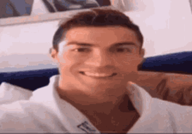 a close up of a man taking a selfie while sitting on a bed .