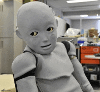a robot with a bald head is standing in a room