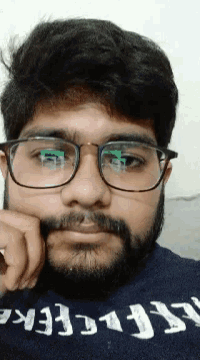 a man with a beard wearing glasses and a shirt that says ' abercrombie ' on it