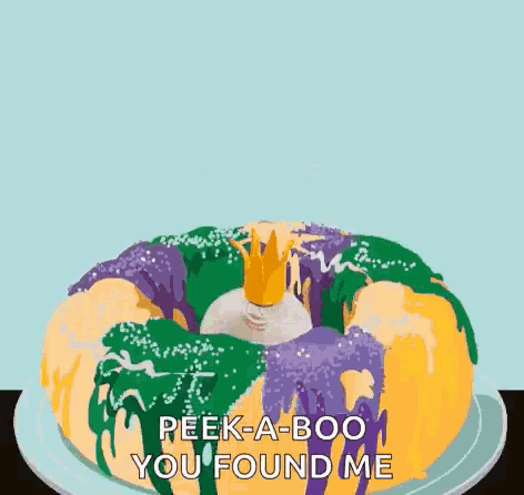 a baby with a crown is sitting on a king cake
