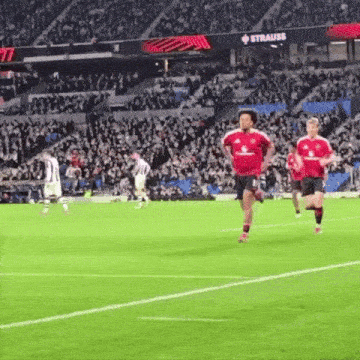 a soccer field with a sign that says strauss
