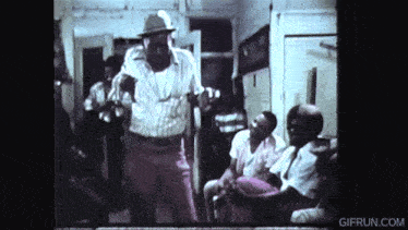 a group of people are gathered in a room and the website gifrun.com is visible in the corner