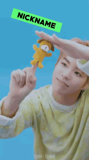 a young man holding a stuffed animal with the words nickname is chow chow written on it