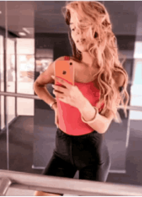 a woman is taking a picture of herself in a mirror