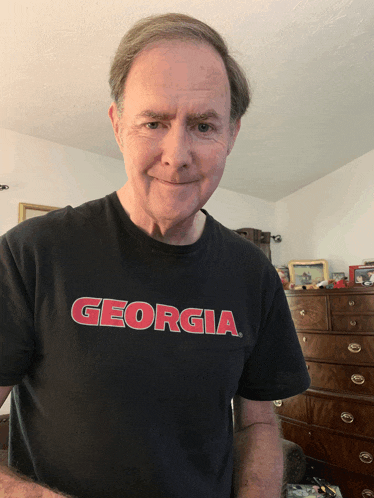 a man is wearing a black georgia shirt