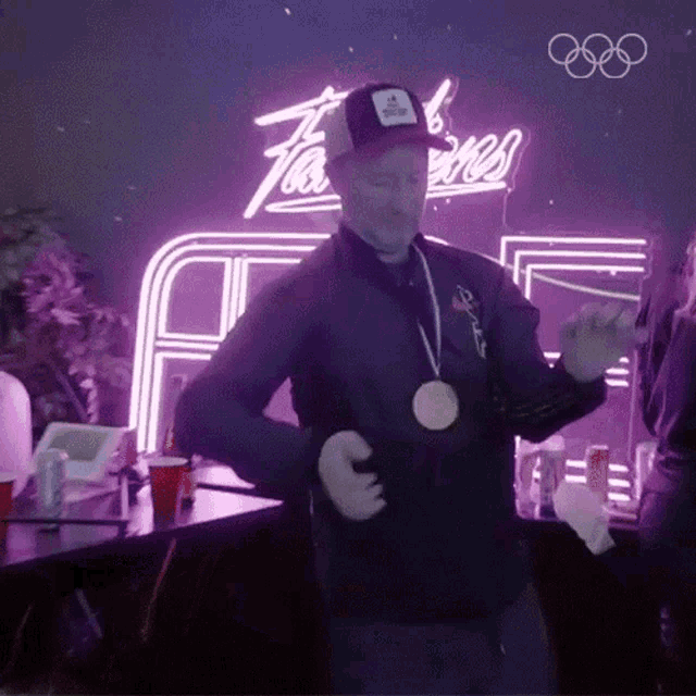 a man wearing a medal around his neck is dancing