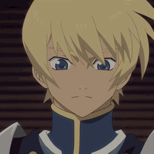 a boy with blonde hair and blue eyes is wearing a blue jacket